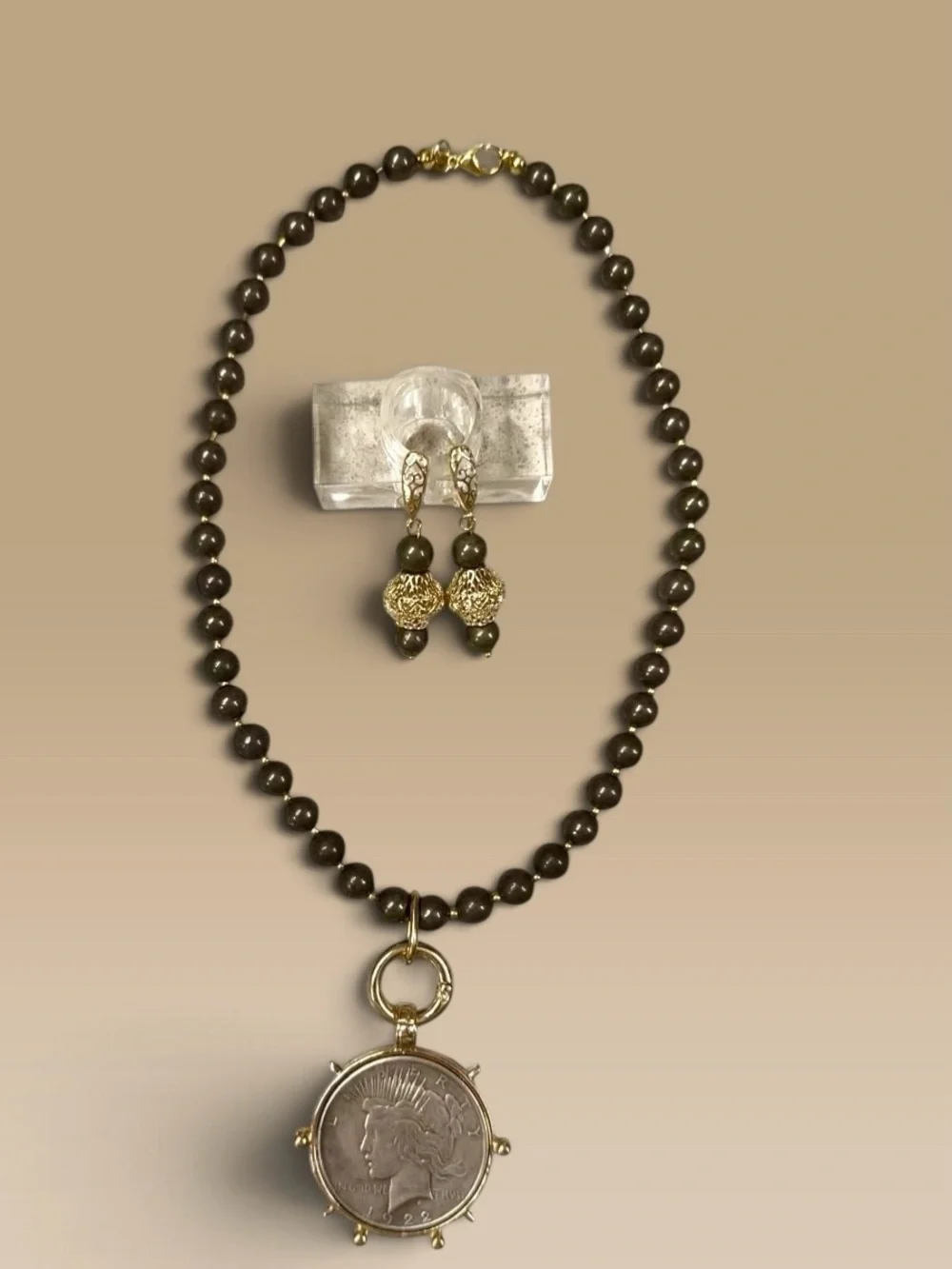 Large silver tone coin in gold tone setting on pyrite necklace with earrings